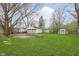 Expansive backyard featuring a well-maintained lawn, detached garage and storage shed at 1946 N Riley Ave, Indianapolis, IN 46218