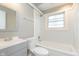 The bathroom features a sink, toilet, and a bathtub with a window at 1946 N Riley Ave, Indianapolis, IN 46218