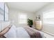 Inviting bedroom with neutral tones, plush bedding, and a large window providing natural light at 1946 N Riley Ave, Indianapolis, IN 46218