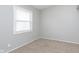 This bedroom features a neutral color scheme, soft carpet, and natural light from the window at 1946 N Riley Ave, Indianapolis, IN 46218