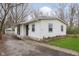Charming single-story home with white siding, manicured lawn, and a detached garage with a private driveway at 1946 N Riley Ave, Indianapolis, IN 46218