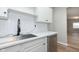 Modern kitchen featuring sleek countertops, stainless steel dishwasher, stylish faucet, and white cabinetry at 1946 N Riley Ave, Indianapolis, IN 46218