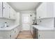 Bright kitchen featuring white cabinets, modern hardware, stainless steel appliances, and sleek marble countertops at 1946 N Riley Ave, Indianapolis, IN 46218