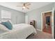 Comfortable bedroom with a queen bed, modern ceiling fan, and a peek into the adjoining room at 1972 Mobley Dr, Westfield, IN 46074