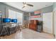 Well-lit room featuring a desk with dual monitors and a Thin Blue Line flag on the wall at 1972 Mobley Dr, Westfield, IN 46074