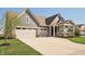 Attractive home showcasing a three-car garage and inviting covered porch at 1972 Mobley Dr, Westfield, IN 46074