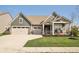 Charming single-Gathering home featuring a three-car garage, covered porch and well-manicured lawn at 1972 Mobley Dr, Westfield, IN 46074