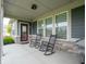 Covered front porch with rocking chairs and a grill, offering a cozy outdoor space at 1972 Mobley Dr, Westfield, IN 46074