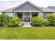 Charming covered porch with inviting seating and lush landscaping, perfect for relaxation at 1972 Mobley Dr, Westfield, IN 46074