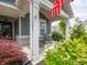 Inviting covered front porch with seating area and charming details with colorful plantings at 1972 Mobley Dr, Westfield, IN 46074