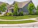 Inviting front yard with a charming, gray home and manicured landscaping at 1972 Mobley Dr, Westfield, IN 46074