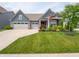 Charming home featuring a well-manicured lawn, beautiful landscaping, and a welcoming covered porch at 1972 Mobley Dr, Westfield, IN 46074