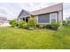 Well-maintained front yard with a charming home featuring a welcoming porch and lush landscaping at 1972 Mobley Dr, Westfield, IN 46074
