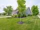Beautifully landscaped front yard with lush green lawn and mature trees at 1972 Mobley Dr, Westfield, IN 46074