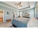 Bright primary bedroom with carpet floors, a ceiling fan, and a decorative tray ceiling at 1972 Mobley Dr, Westfield, IN 46074