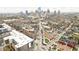 An aerial view showcases the cityscape, surrounded by buildings and streets with spring blooming trees at 2043 Winthrop Ave, Indianapolis, IN 46202