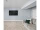 Cozy basement area featuring a comfortable sofa, plush carpeting, and a large television at 2043 Winthrop Ave, Indianapolis, IN 46202