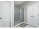 Modern bathroom featuring a walk-in shower with sleek glass doors, complemented by fresh, clean white doors at 2043 Winthrop Ave, Indianapolis, IN 46202