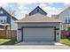 A modern two-car garage exterior featuring updated lighting and a well-maintained driveway at 2043 Winthrop Ave, Indianapolis, IN 46202