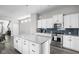 Bright, modern kitchen features white cabinets, a large island, and stainless steel appliances at 2043 Winthrop Ave, Indianapolis, IN 46202