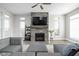 Comfortable living room features a stone fireplace and ample natural light, perfect for relaxing at 2043 Winthrop Ave, Indianapolis, IN 46202