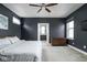 This spacious main bedroom features an ensuite bathroom, a ceiling fan, and a neutral color palette at 2043 Winthrop Ave, Indianapolis, IN 46202