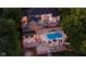 Aerial view of a sprawling lakefront estate with a pool, tiered decks, and lush landscaping at 219 Surrey Hill, Noblesville, IN 46062