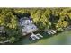 Beautiful waterfront home with a private pool and multiple boat docks surrounded by lush greenery at 219 Surrey Hill, Noblesville, IN 46062