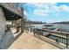 View of a large waterfront patio and covered dock with boat lifts on a sunny day at 219 Surrey Hill, Noblesville, IN 46062