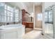 Bright bathroom with a soaking tub, separate shower, and ample cabinet space at 219 Surrey Hill, Noblesville, IN 46062