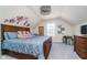 Cozy bedroom featuring a decorative wall art, plush pillows, and a charming dollhouse at 219 Surrey Hill, Noblesville, IN 46062