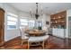 Cozy dining area with hardwood floors, a chandelier, and views of the lake at 219 Surrey Hill, Noblesville, IN 46062