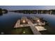 Illuminated boat dock at dusk offering direct water access and scenic views of the lake at 219 Surrey Hill, Noblesville, IN 46062