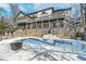 Expansive back of house featuring walk-out basement with large windows and a gorgeous pool and deck at 219 Surrey Hill, Noblesville, IN 46062