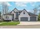 Traditional two-story home with a three-car garage and freshly mowed lawn in a suburban neighborhood on a clear day at 219 Surrey Hill, Noblesville, IN 46062
