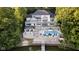 Aerial view of a luxurious home featuring a swimming pool, multiple decks, and lake access at 219 Surrey Hill, Noblesville, IN 46062