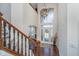 Bright and airy two-story foyer featuring hardwood floors, a statement chandelier, and decorative glass front door at 219 Surrey Hill, Noblesville, IN 46062