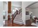 Spacious entry featuring hardwood floors, a grand staircase, a stone fireplace and an open view of the dining room at 219 Surrey Hill, Noblesville, IN 46062