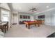 Entertaining game room features a pool table and adjacent seating area, ideal for gatherings at 219 Surrey Hill, Noblesville, IN 46062