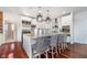Bright kitchen with modern appliances, a large island, and stylish pendant lighting at 219 Surrey Hill, Noblesville, IN 46062