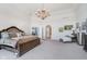 Spacious main bedroom with a chandelier, chaise lounge, and ample space at 219 Surrey Hill, Noblesville, IN 46062