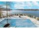 Stunning aerial view of a luxurious pool and waterfront deck overlooking the lake with stone retaining walls at 219 Surrey Hill, Noblesville, IN 46062