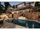 Gorgeous in-ground swimming pool and stone work on a home overlooking the lake at night at 219 Surrey Hill, Noblesville, IN 46062