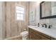 Elegant powder room with stylish fixtures, wood-look accent wall, and a modern vanity at 219 Surrey Hill, Noblesville, IN 46062