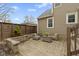 Relaxing back patio with neutral furniture, low stone wall, and horizontal wood-slat fence at 2210 Douglas Rd, Indianapolis, IN 46220