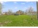 Expansive lawn backyard features covered pool, fences, and the home's rear elevation at 2210 Douglas Rd, Indianapolis, IN 46220