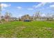 Large, grassy backyard with an above-ground pool, fence, and view of the back of the house at 2210 Douglas Rd, Indianapolis, IN 46220