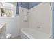Bathroom featuring a bathtub and tiled wall at 2210 Douglas Rd, Indianapolis, IN 46220