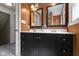 Stylish bathroom featuring a double sink vanity and two framed mirrors above at 2210 Douglas Rd, Indianapolis, IN 46220