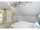 Bedroom with sloped ceilings, fan, and built-in storage with adjacent door at 2210 Douglas Rd, Indianapolis, IN 46220